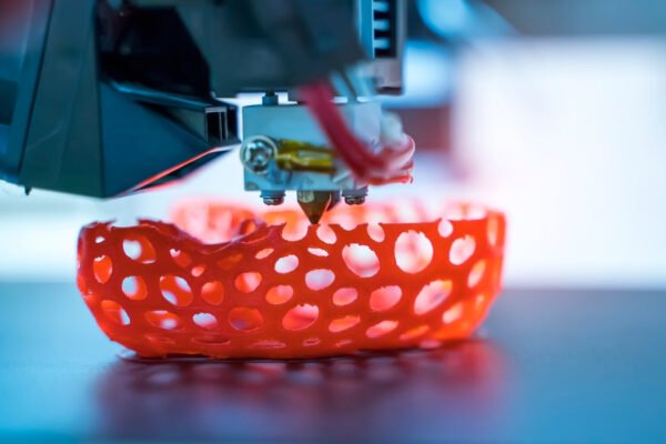 3D nyomtatás folyamat, piros fényű, perforált alakzat készül